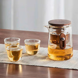 Portable glass travel tea set with teapot, three cups, and travel case displayed neatly.